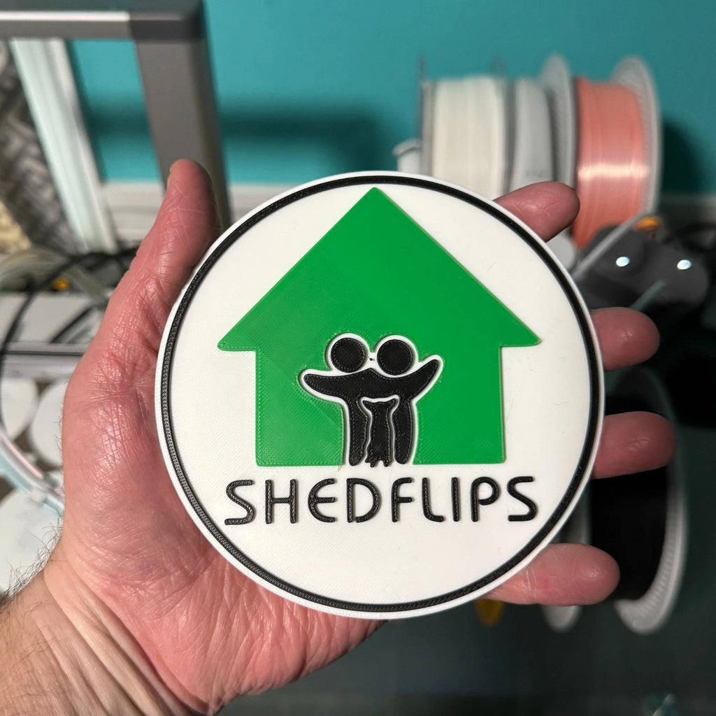 Shed Flips logo magnet, hand held in the shed