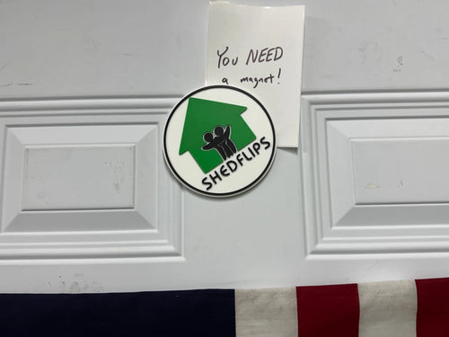 Shed Flips magnet on a fridge holding a 'You NEED a magnet!' note
